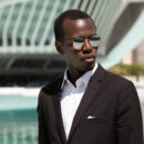 outdoor-close-up-portrait-handsome-confident-young-afro-american-dressed-formally-standing-street-urban-setting-with-modern-office-building